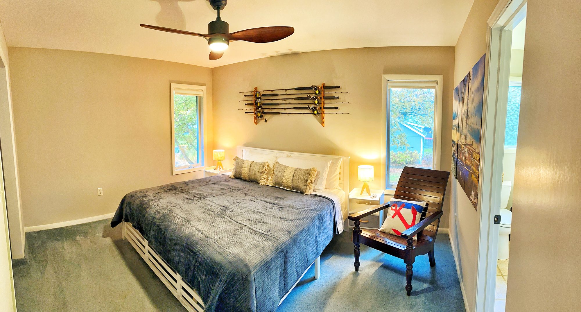 Bedroom 1 king bed with fishing rods on the wall